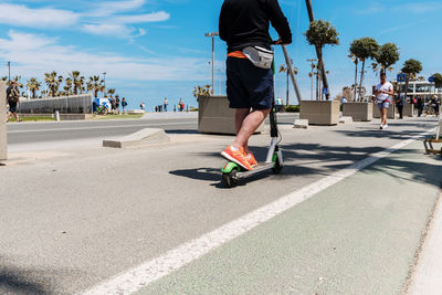 Man riding skateboard on road