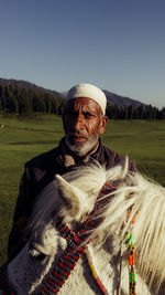 Portrait of man wearing hat against sky