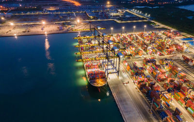 High angle view of illuminated harbor in city at night