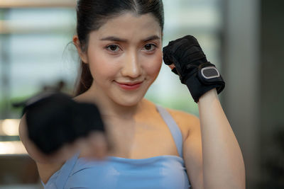 Portrait of young woman holding camera