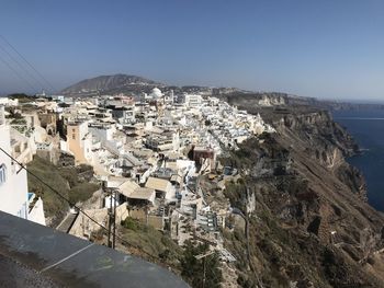 High angle view of townscape by sea against sky