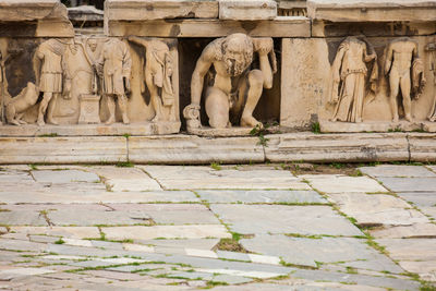 View of statues on stone wall