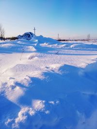 Scenic view of snow covered land against blue sky