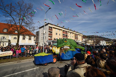 Crowd in city against sky