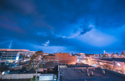 High angle view of illuminated buildings against sky at night