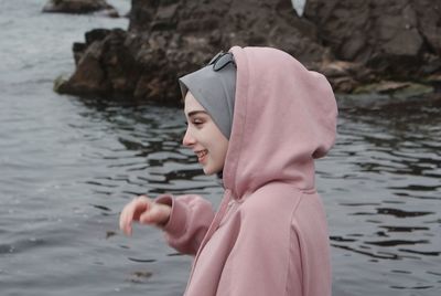 Portrait of young woman standing in lake