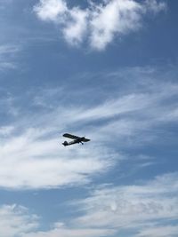 Low angle view of airplane flying in sky