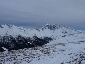 Scenic view of snow covered mountains against sky