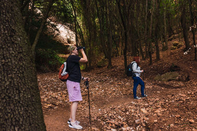 Two friends climbing to the top of a mountain. young women on vacation. 