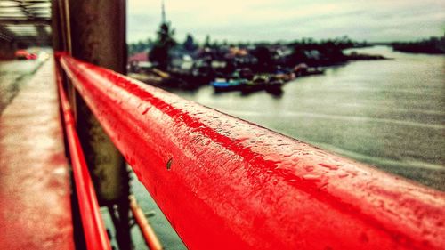 Close-up of red railing in city