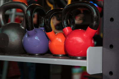 Close-up of multi colored kettlebells on rack