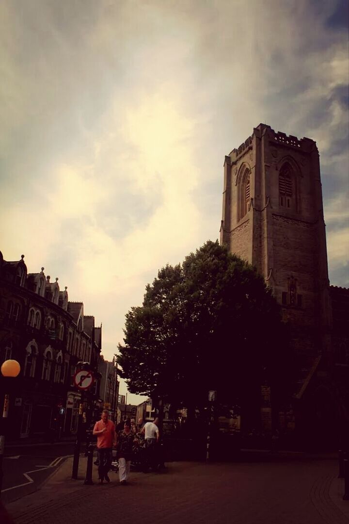 architecture, building exterior, built structure, sky, cloud - sky, tree, street, cloud, cloudy, religion, city, road, church, incidental people, outdoors, place of worship, travel destinations, transportation