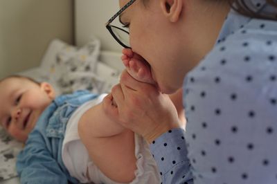 Mother changing diapers of cute little baby boy