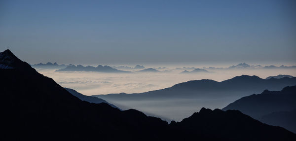 Scenic view of mountain range during foggy weather