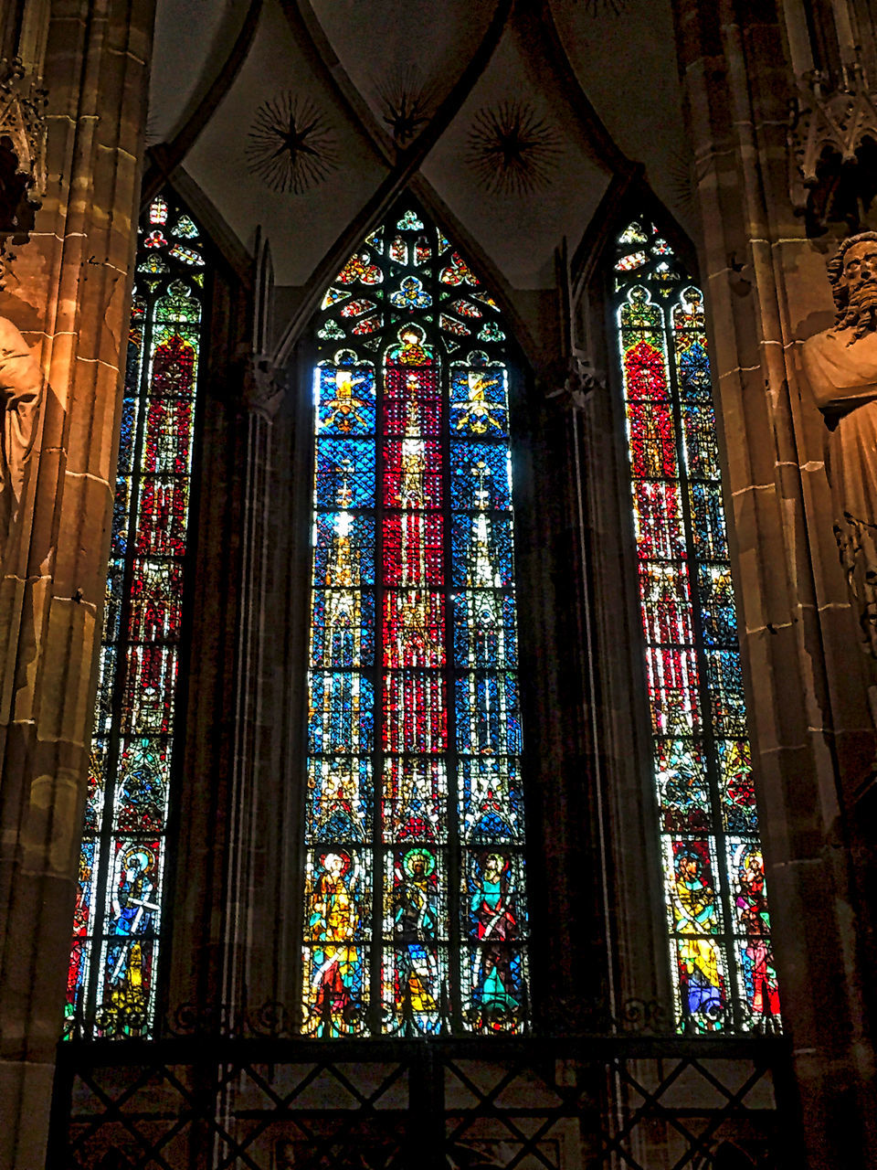 window, stained glass, multi colored, indoors, religion, spirituality, low angle view, art, place of worship, church, art and craft, ceiling, glass - material, colorful, glass, multicolored, architectural column, tranquility, art product, architecture and art, creativity, red color