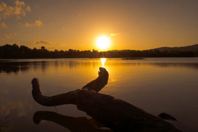 Scenic view of lake against sky during sunset