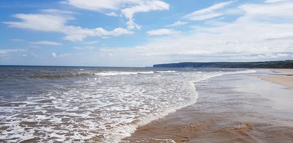 Scenic view of beach against sky