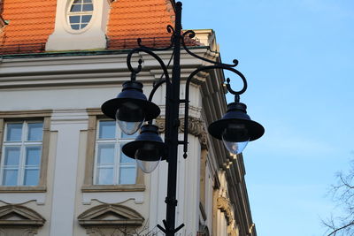 Low angle view of street light against building