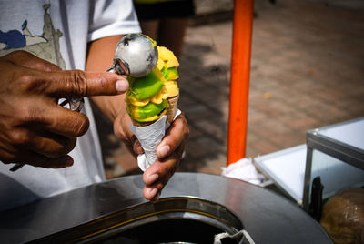 Midsection of vendor selling ice cream cones