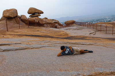 Man lying on rock