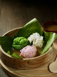 Close-up of putu mayang cake in wood bowl on table