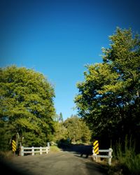 Road against clear blue sky