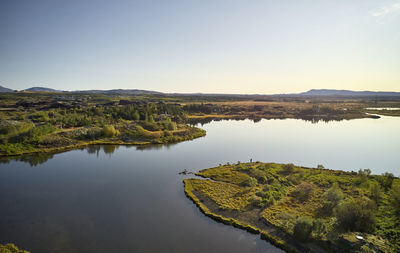 Peaceful scenery of winding river shore in fair weather