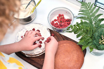 High angle view of woman preparing food on table