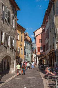 Colorful old buildings and pedestrians, in the city center of annecy, france.