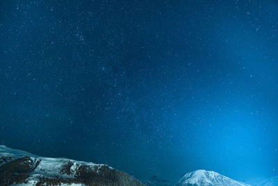 Scenic view of mountain against sky at night