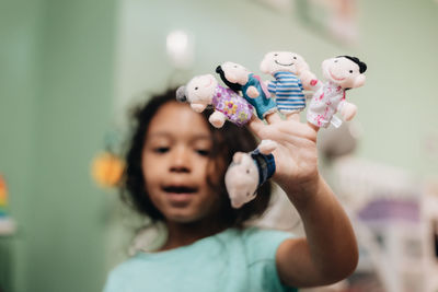 Portrait of cute girl holding toy