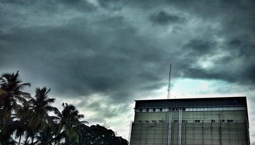 Low angle view of building against cloudy sky