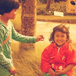 Girl touching sister in park