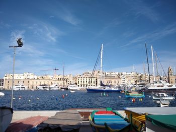 Sailboats moored at harbor