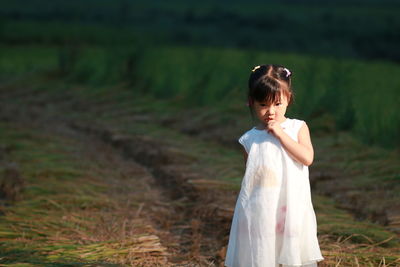 Cute girl standing on field