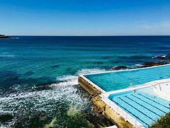 High angle view of swimming pool by sea against sky