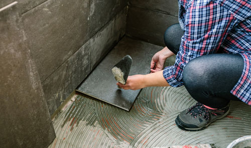 Low section of man sitting on floor