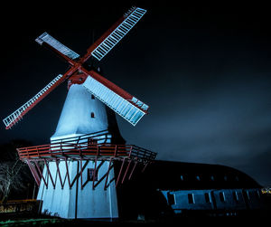 Traditional windmill against sky at night