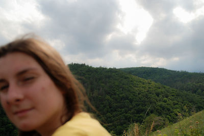 Woman looking at landscape against sky