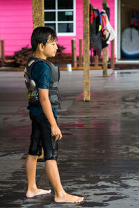 Full length of boy standing in street