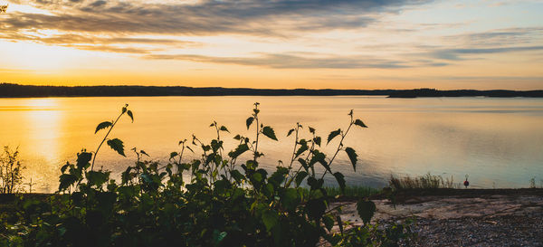 Scenic view of lake against sky during sunset