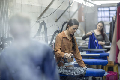 Seamstresses ironing clothes in factory