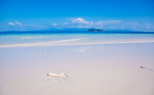 Scenic view of beach against blue sky