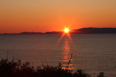 Scenic view of sea against romantic sky at sunset