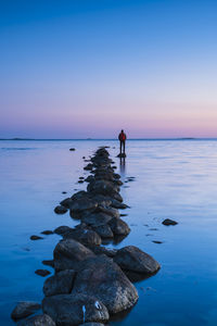 Person standing on breakwater