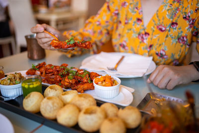 Midsection of woman having food