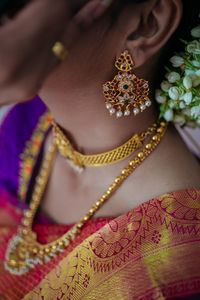 Midsection of woman wearing necklace