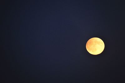 Low angle view of moon against clear sky at night
