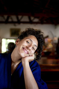 Mixed race woman looking at camera and smiling.