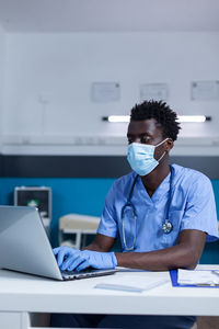 Nurse wearing mask working in clinic